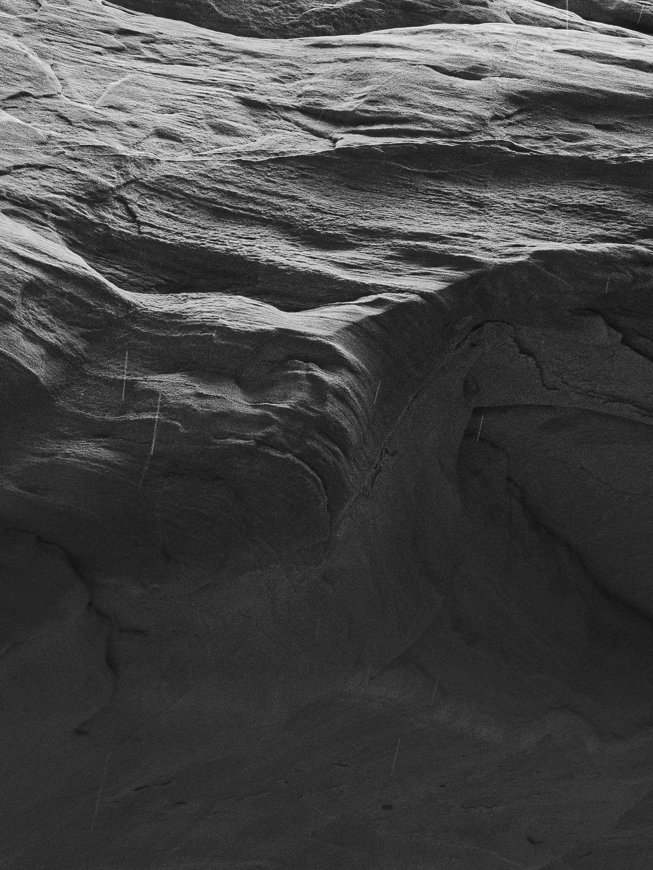 Wind-sculpted sandstone folds into darkness, an intimate study in erosion.