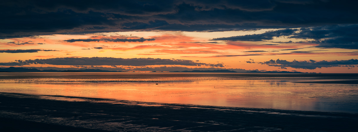Sunset embers reflect across the still waters of the Great Salt Lake.